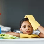 Portrait of a woman cleaning in home