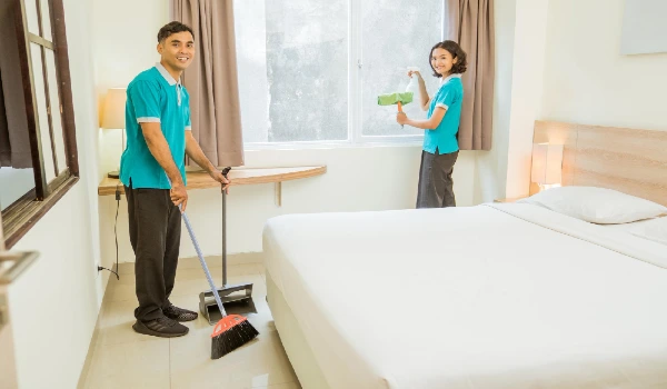 Low section of man cleaning floor at home