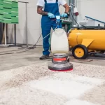 Professional worker doing his job at carpet washing service.