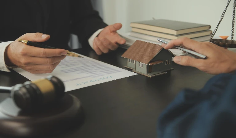 Justice and law concept legal counsel presents to the client a signed contract with gavel and legal law or legal having team meeting at law firm in background