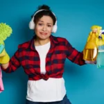 Upset young mixed race woman holding cleaning supplies and products in the hands