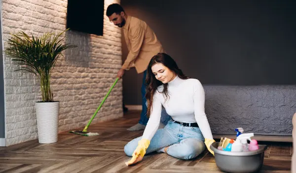 Young family cleaning their apartment home. Housekeeping and home cleaning concept