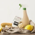 Eco cleaning kit with mesh bag on the table spray bottle soda lemon and natural cleaning sponges