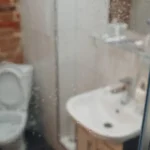 Blurred background flush toilet in bathroom at apartments