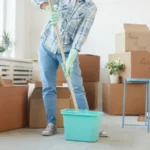 Low section portrait of happy young woman cleaning new house or apartment while moving in
